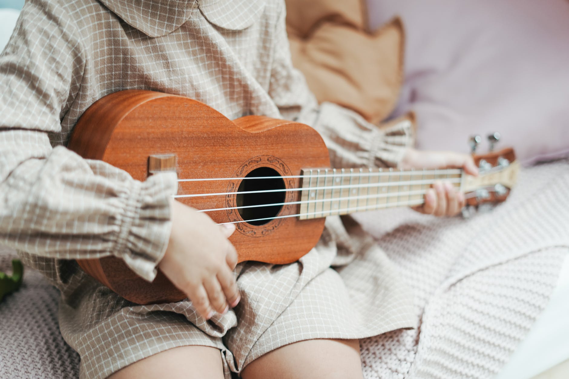 photo of a toddler playing a ukulele